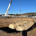 Heavy-duty fiberglass underground fuel storage tanks being lowered into position in Tasmania.
