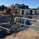 Detailed view of the complex pipework and containment sumps for a fuel station forecourt.